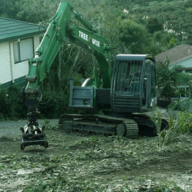 Green excavator clearing land