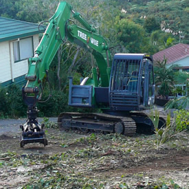 Green excavator clearing land